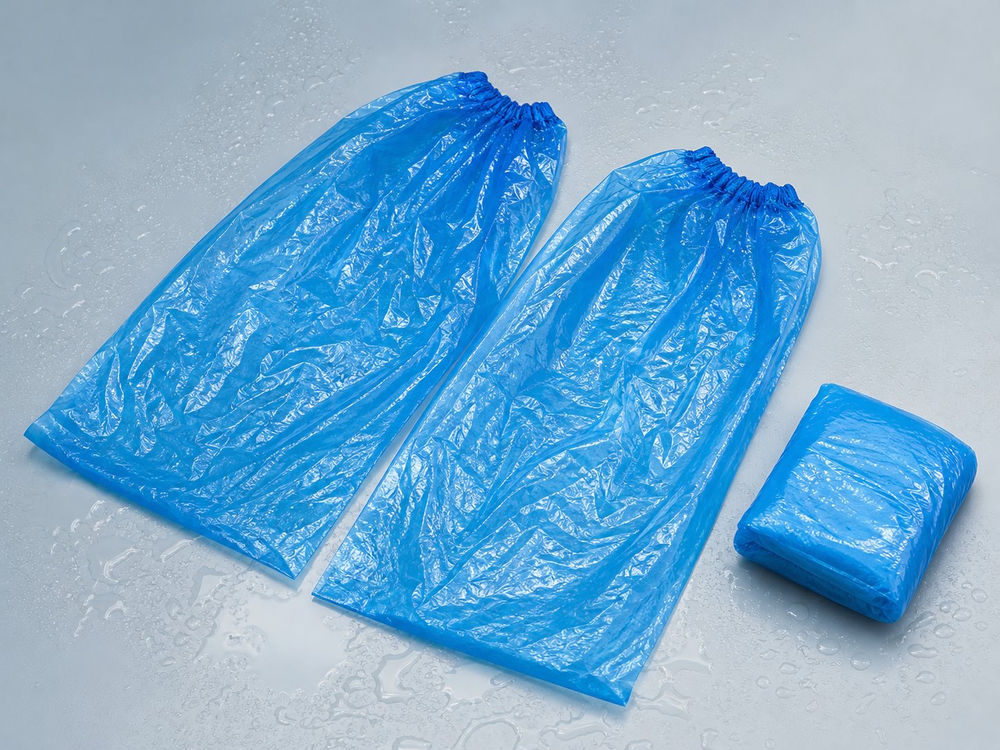 Flat lay of folded and unfolded disposable rain shoe covers